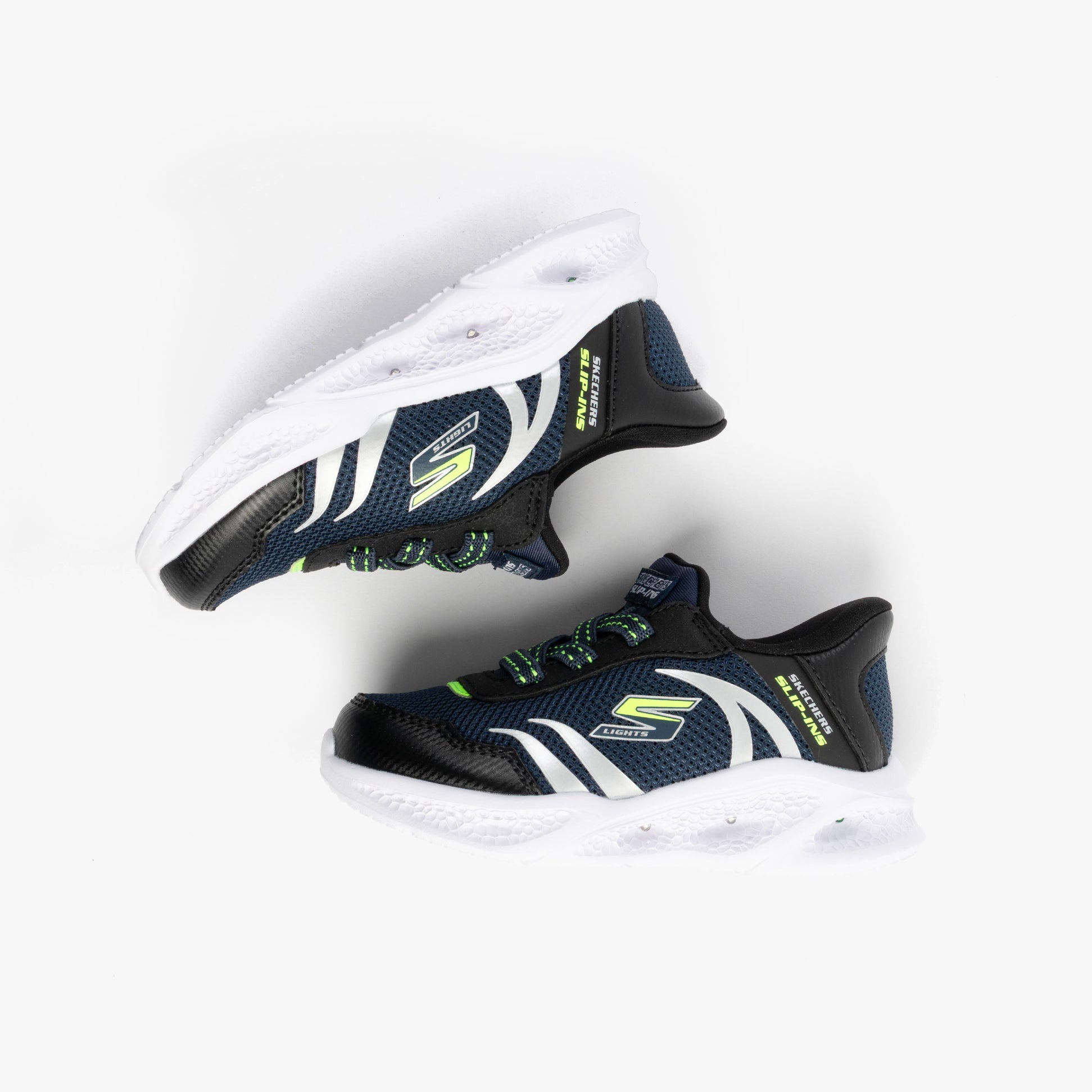 Skechers 403848N/NVBK METEOR-LIGHTS-BRISK-BEAMS Boys Trainers Navy/Black side view with white sole and neon accents.