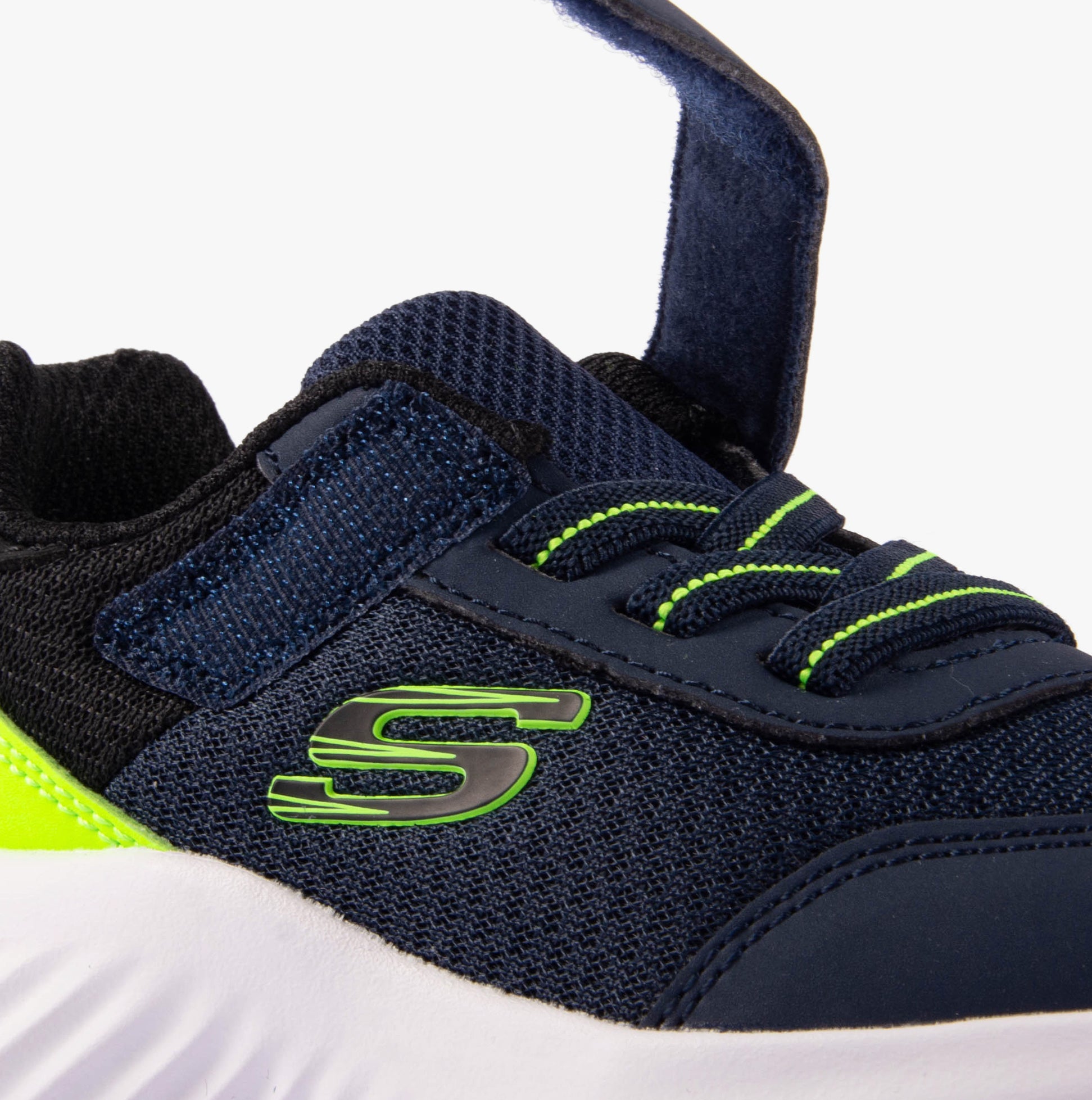 Skechers 403908N/NVLM BOUNDER - TREZIC Boys Trainers Navy/Lime close-up side view revealing synthetic upper and lace-up design.