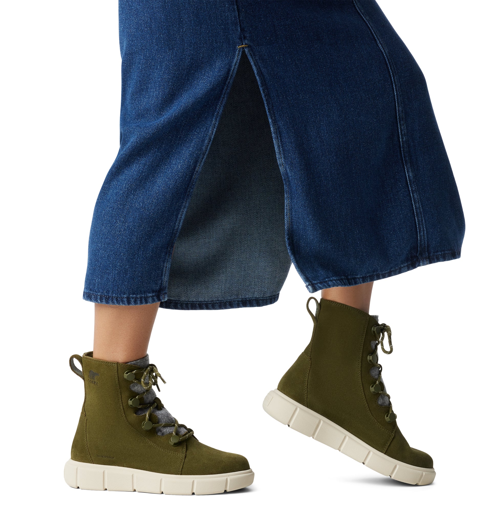 Sorel EXPLORER III JOAN Womens Winter Boots Green side view on model's feet with denim skirt