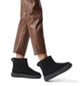 Sorel EXPLORER III SLIP-ON Womens Winter Boots Black side view worn with brown pants.