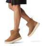 Sorel EXPLORER III SLIP-ON Womens Winter Boots Brown side view on model's feet with casual outfit.