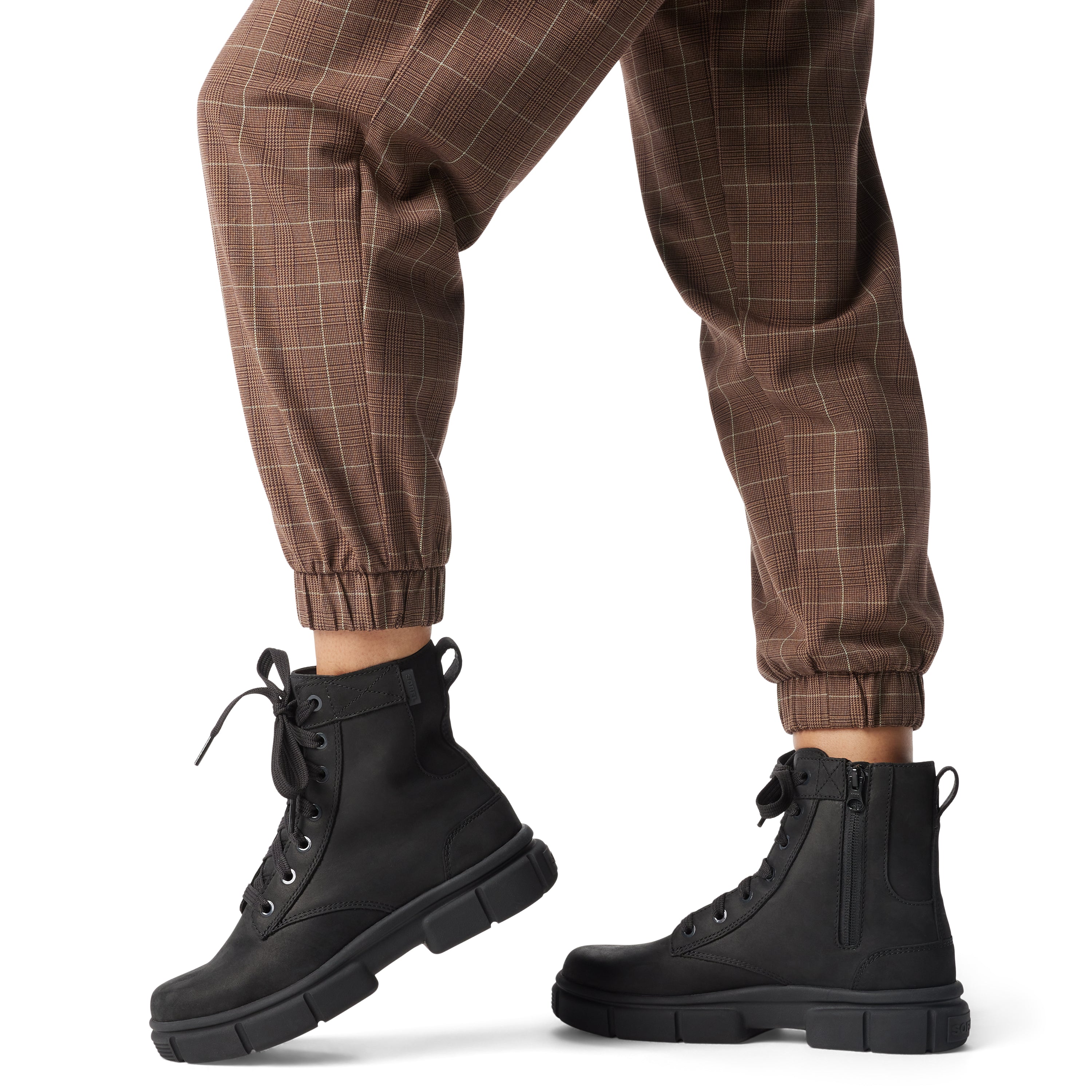 Sorel EXPLORER STRT LACE Womens Boots Black side view with model wearing checkered pants.