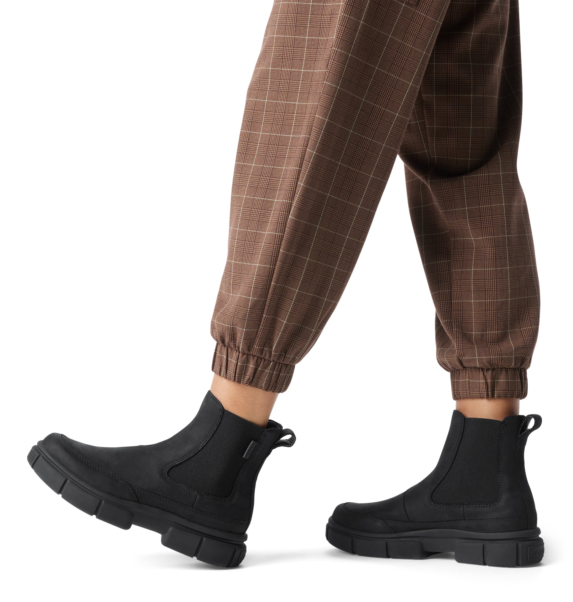 Sorel EXPLORER STRT Womens Chelsea Boots Black side view worn with brown plaid pants