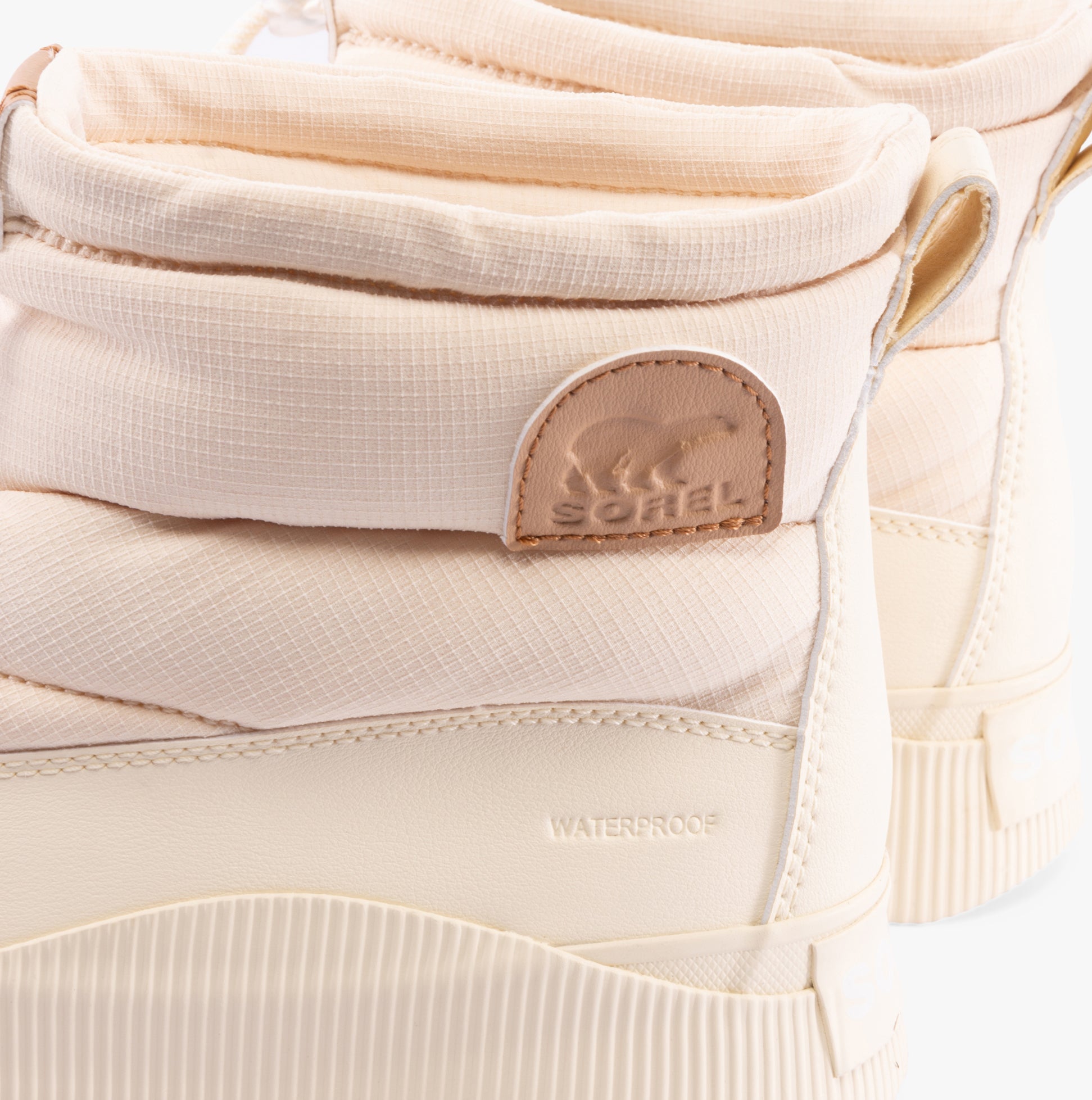 Sorel OUT N ABOUT IV PUFFY Womens Winter Boots Brown detail view showing the waterproof feature and logo.