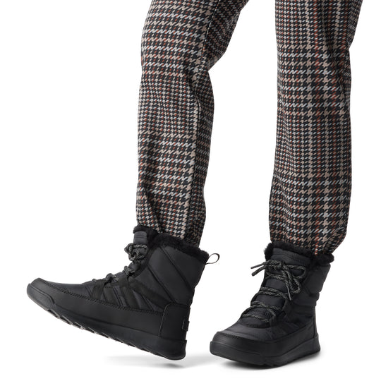 Sorel WHITNEY II PLUS LACE Womens Winter Boots Black side view worn with stylish pants.