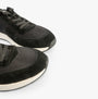 TOMS TRVL LITE RETRO Mens Trainers Black close-up view showcasing suede upper and lace-up design.