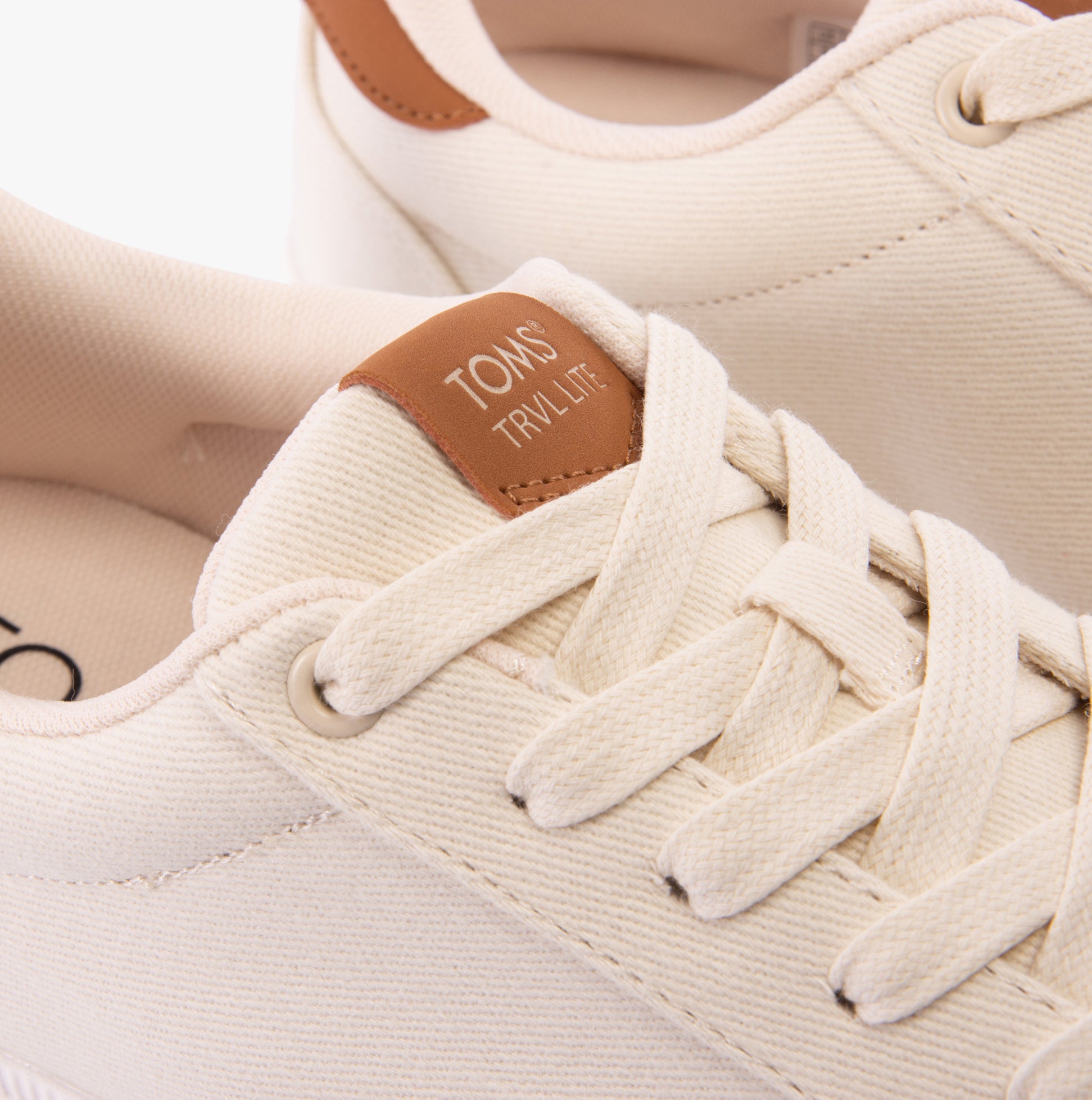 Detail view of TOMS TRVL LITE RIO Mens Trainers Beige, showcasing the textile upper and lace-up closure.