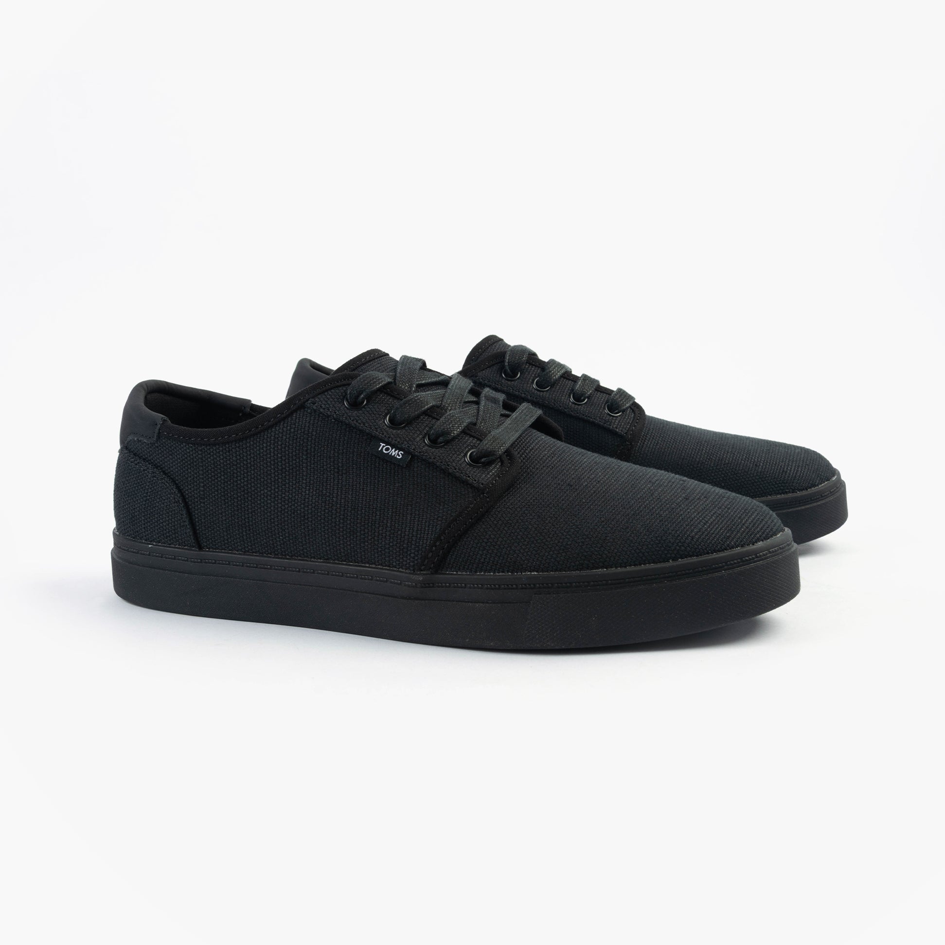 TOMS CARLO 2.0 Mens Trainers Black side view showing lace-up black canvas shoes with rubber sole.