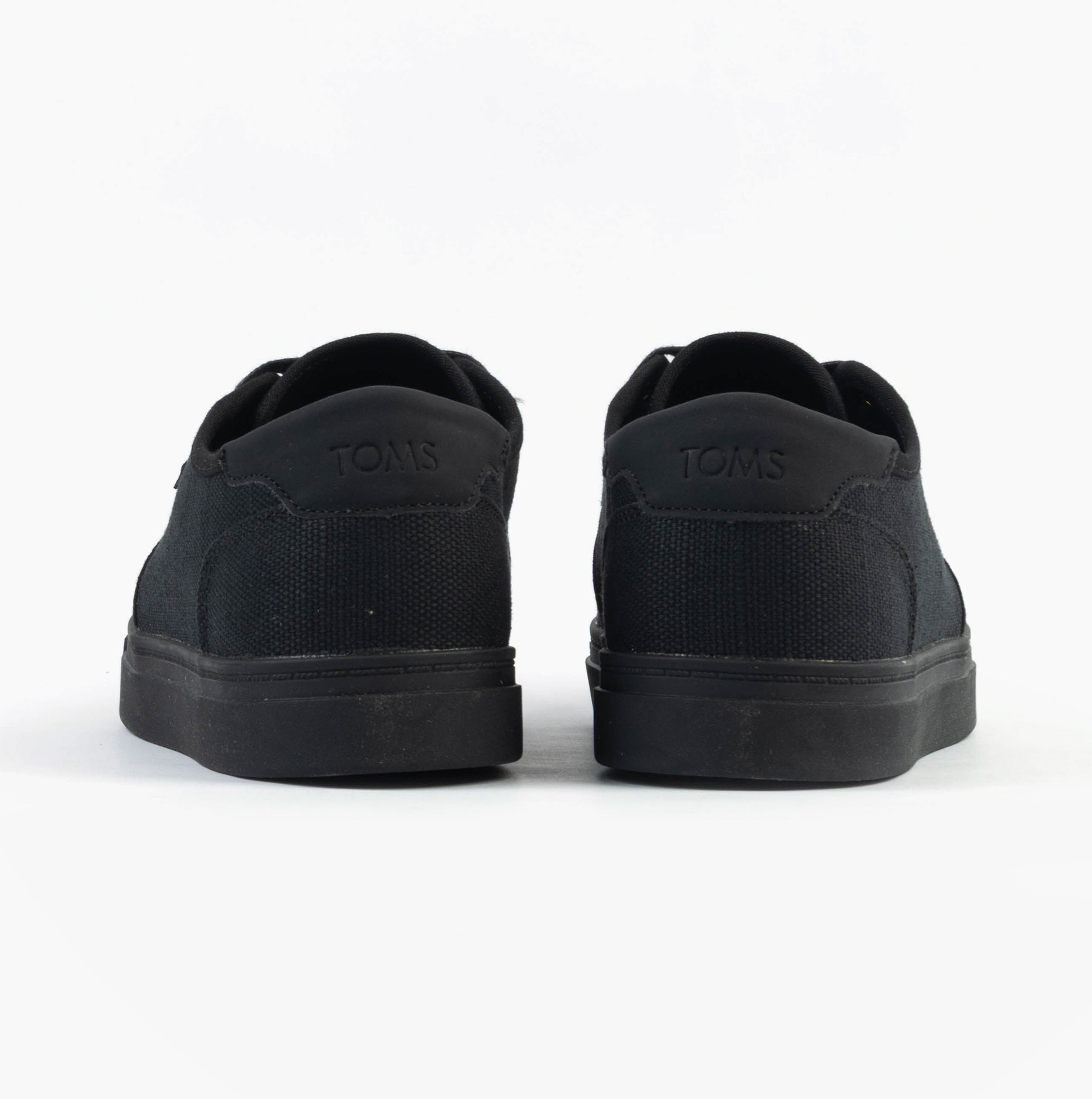 TOMS CARLO 2.0 Mens Trainers Black rear view showing canvas upper and rubber sole.