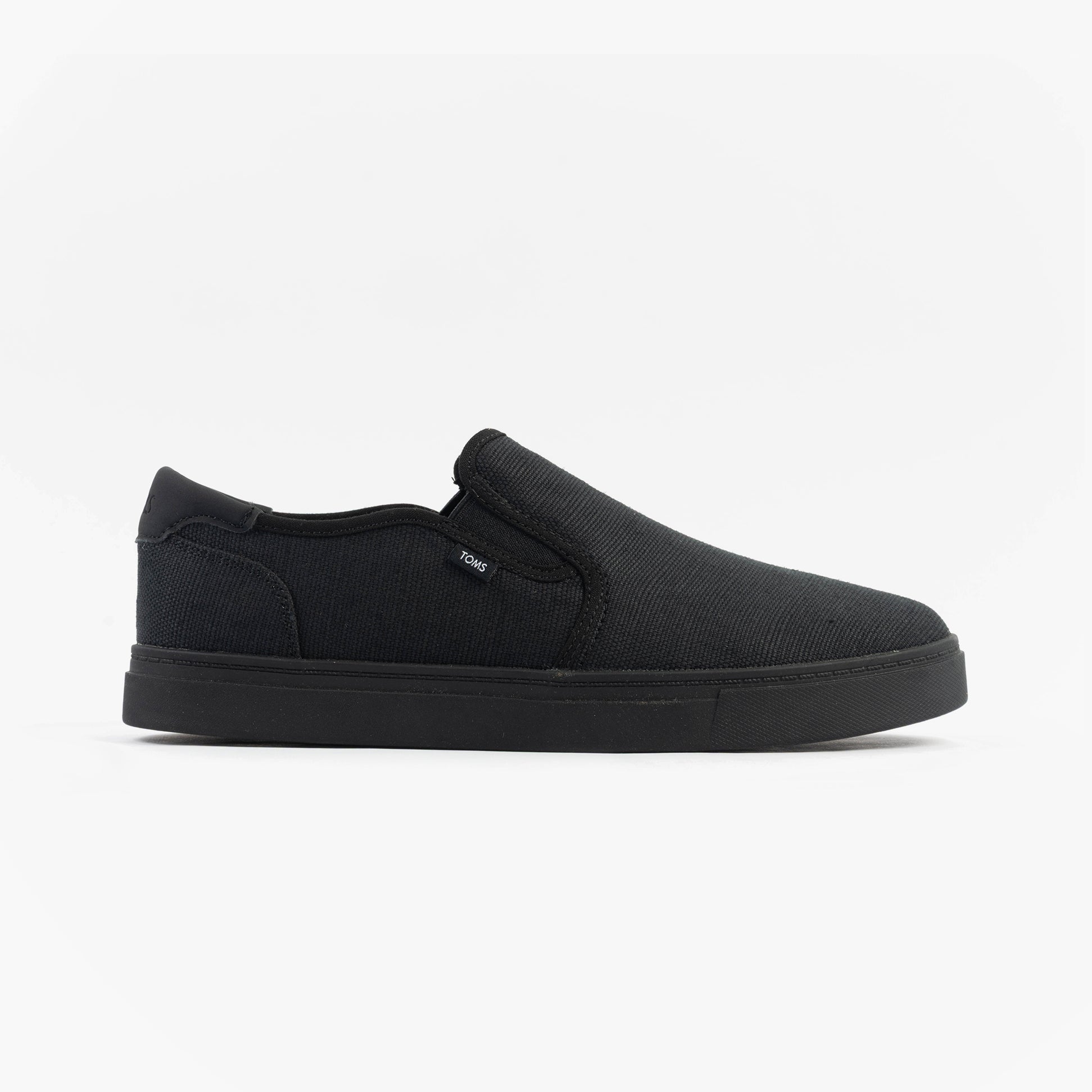 TOMS BAJA 2.0 Mens Casual Canvas Trainers Black side view with slip-on design and black canvas upper.
