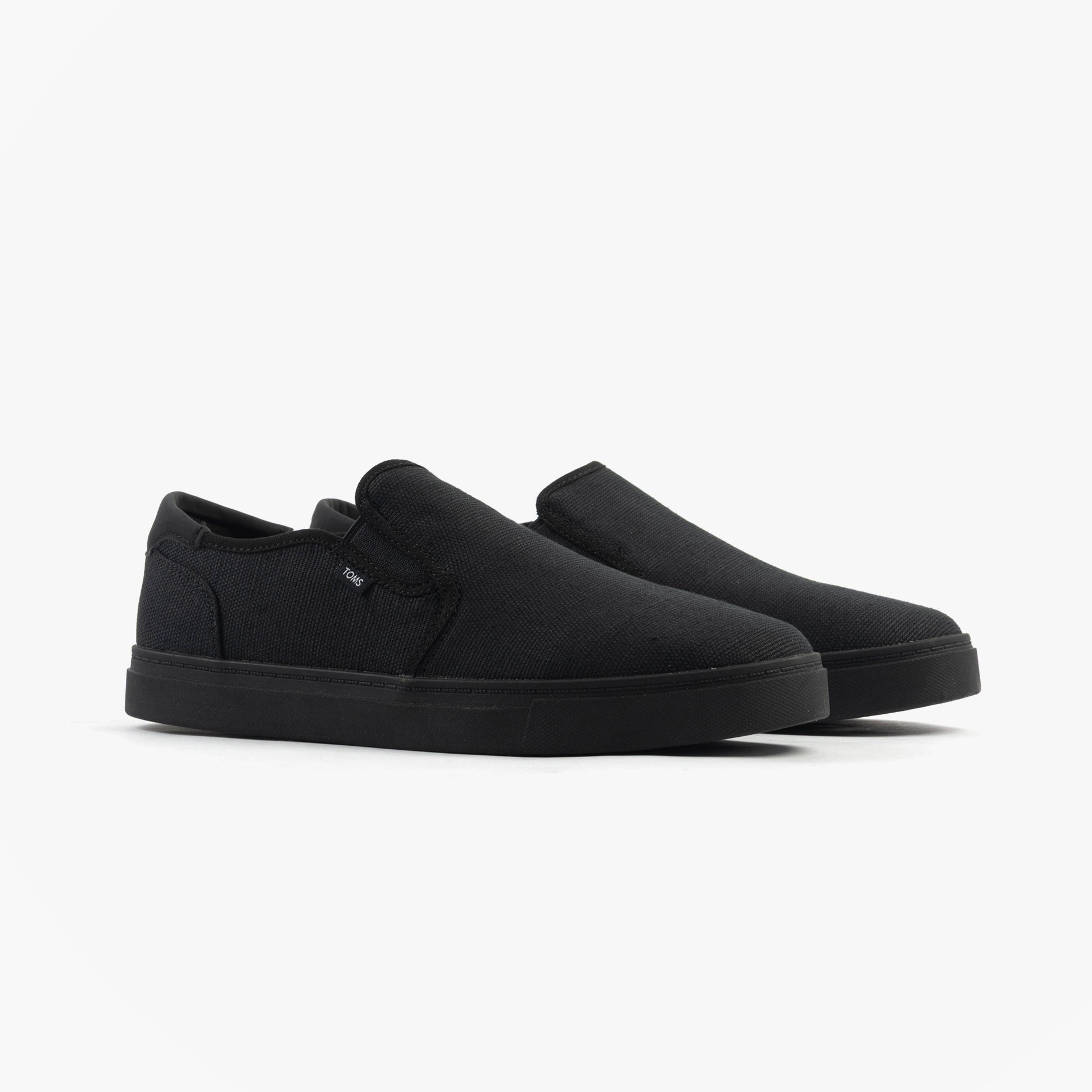 TOMS BAJA 2.0 Mens Casual Canvas Trainers Black side view showcasing slip-on style and low-top design.