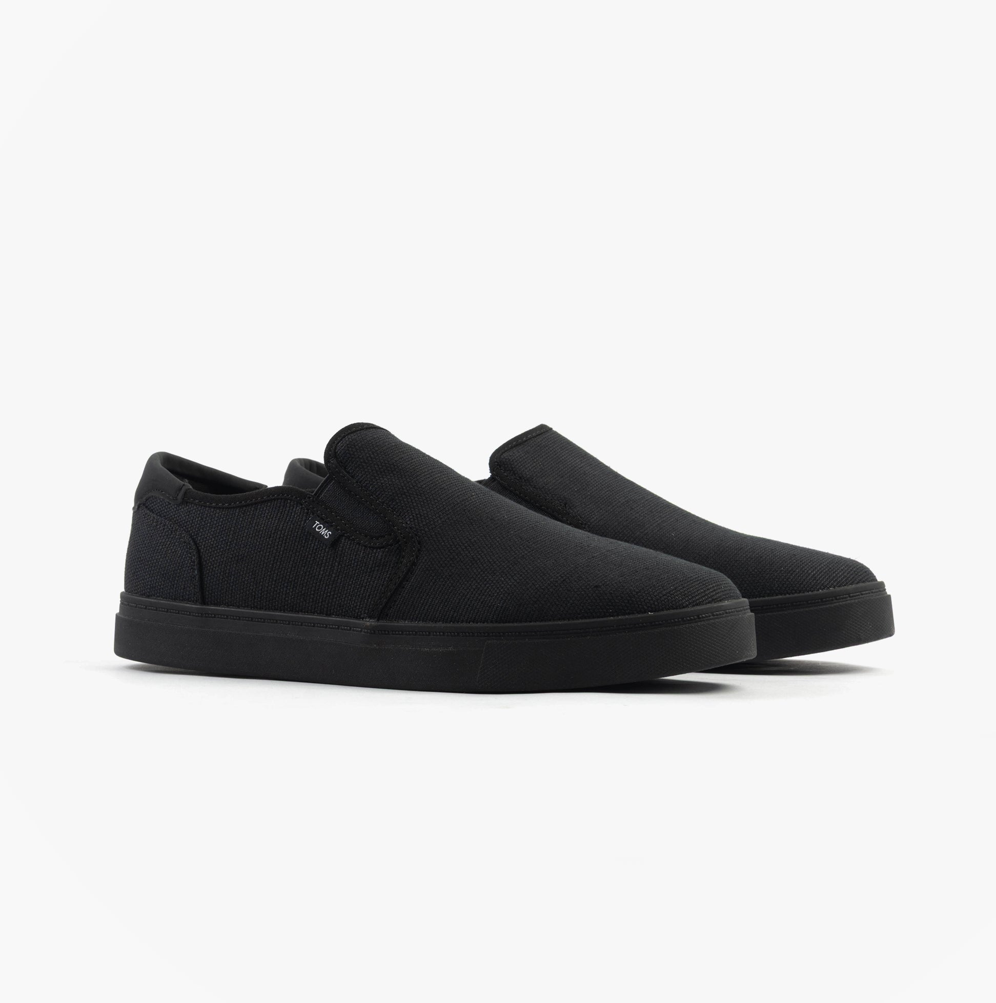 TOMS BAJA 2.0 Mens Casual Canvas Trainers Black side view showcasing slip-on style and low-top design.