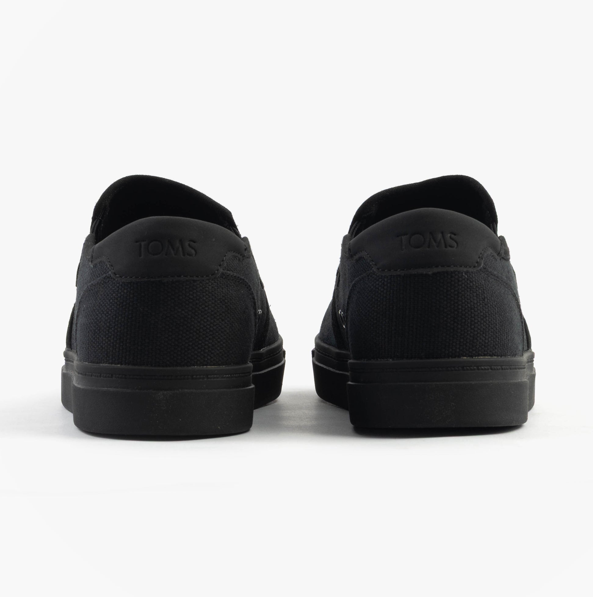 TOMS BAJA 2.0 Mens Casual Canvas Trainers Black back view showcasing low top design and slip-on style.