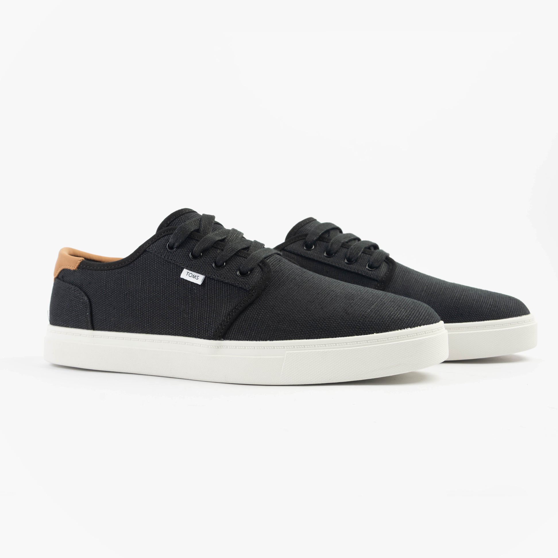TOMS CARLO 2.0 Mens Trainers Black side view showcasing black canvas upper and white rubber sole.