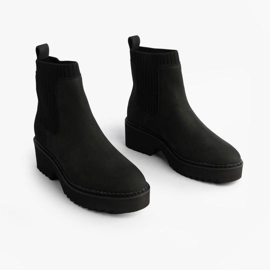 TOMS MILLIE Womens Ankle Boots Black side view showcasing sleek leather design and comfortable pull-on style.