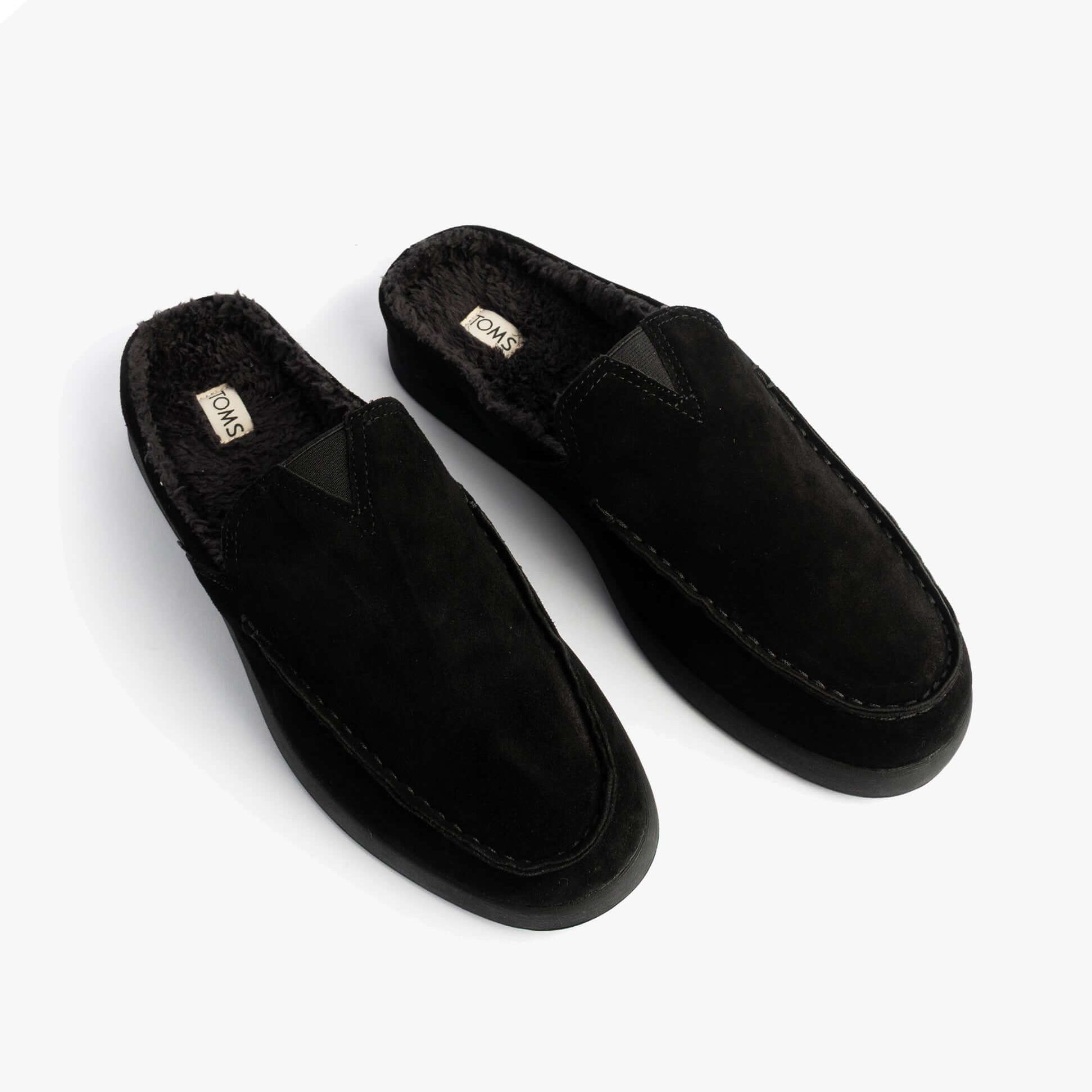 TOMS ALONSO MULE Mens Faux Shearling Lined Slippers Black, top view of slippers showing suede upper and shearling lining.