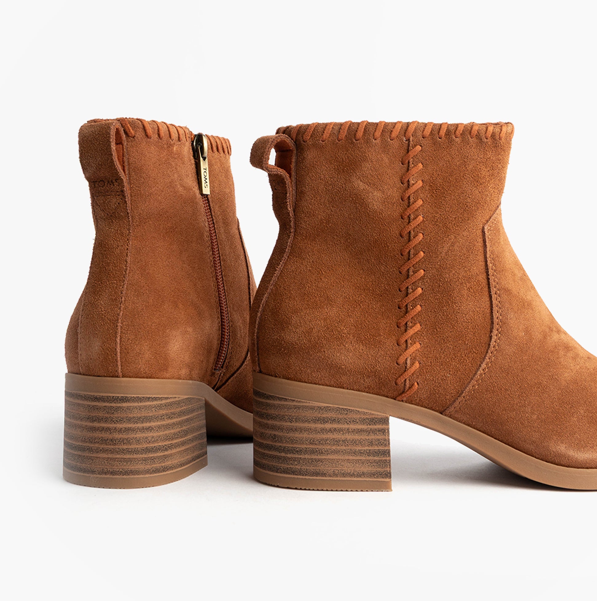 TOMS DELILAH Womens Ankle Boots Brown side view showcasing the suede texture and zip closure detail.