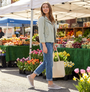 Woman walking in a farmers market wearing skechers footwear