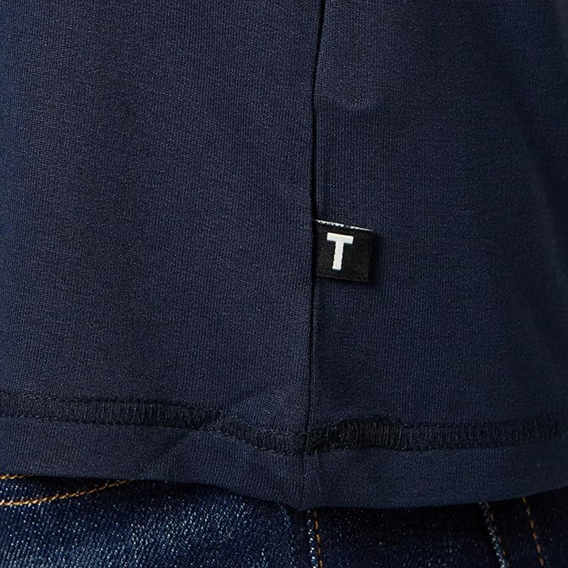 Ted Baker SUPER SOFT Long Sleeve Top Mens Navy detail view showing hem tag and fabric texture.