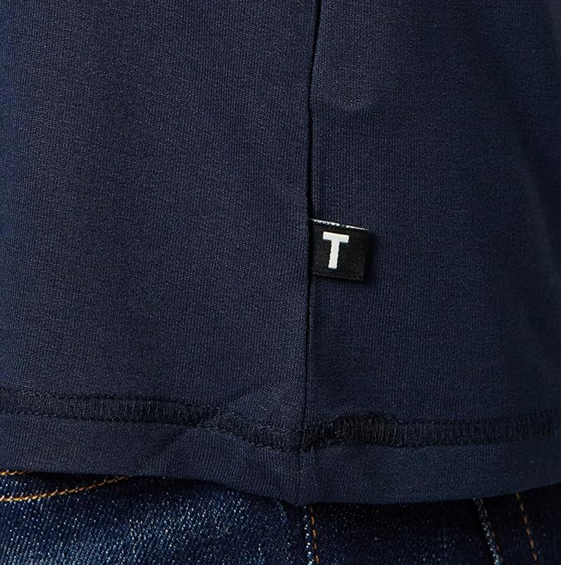 Ted Baker SUPER SOFT Long Sleeve Top Mens Navy detail view showing hem tag and fabric texture.