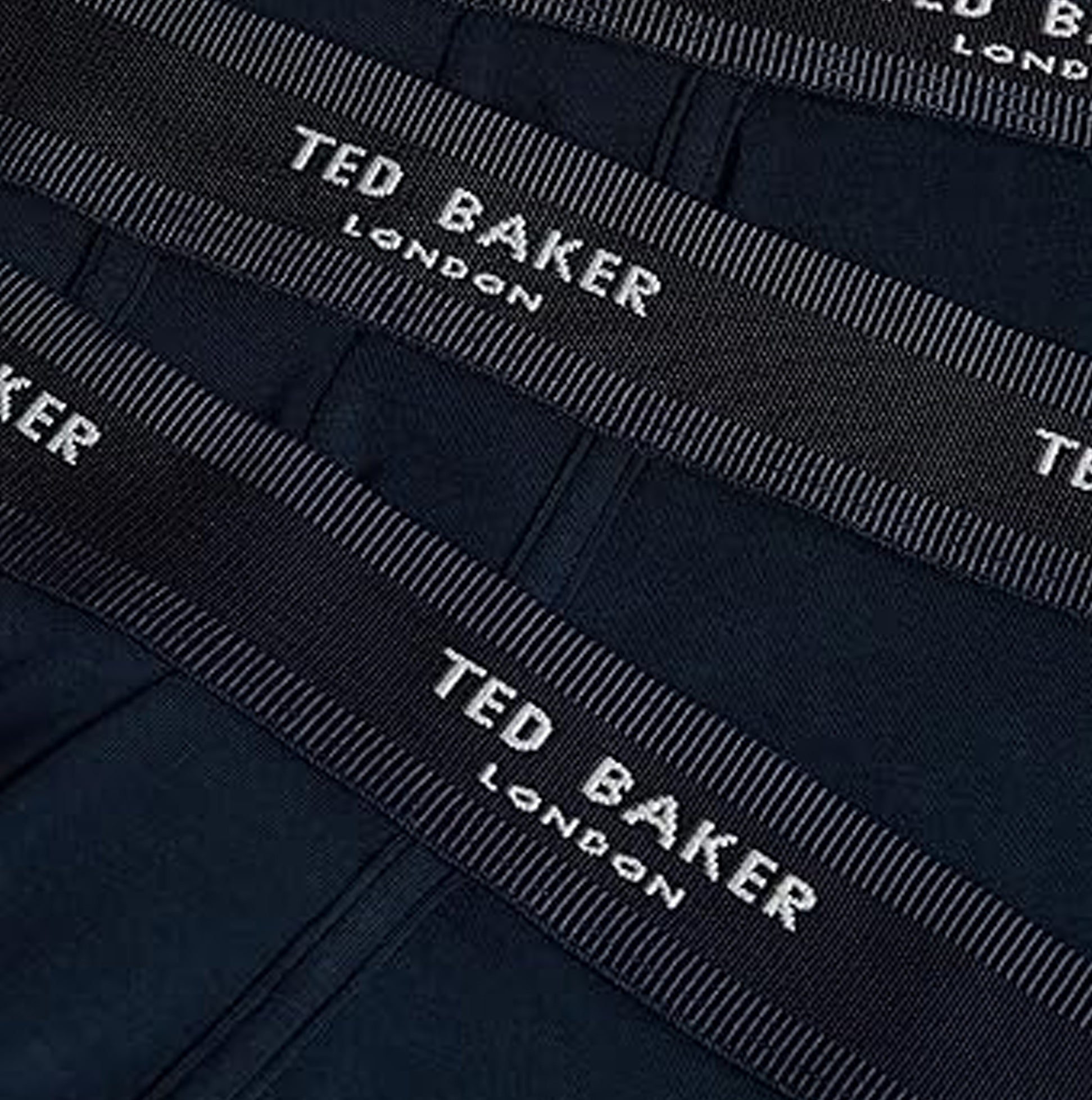 Detail view of Ted Baker 3-Pack Cotton Trunks Mens Navy showing waistband logo and navy material.