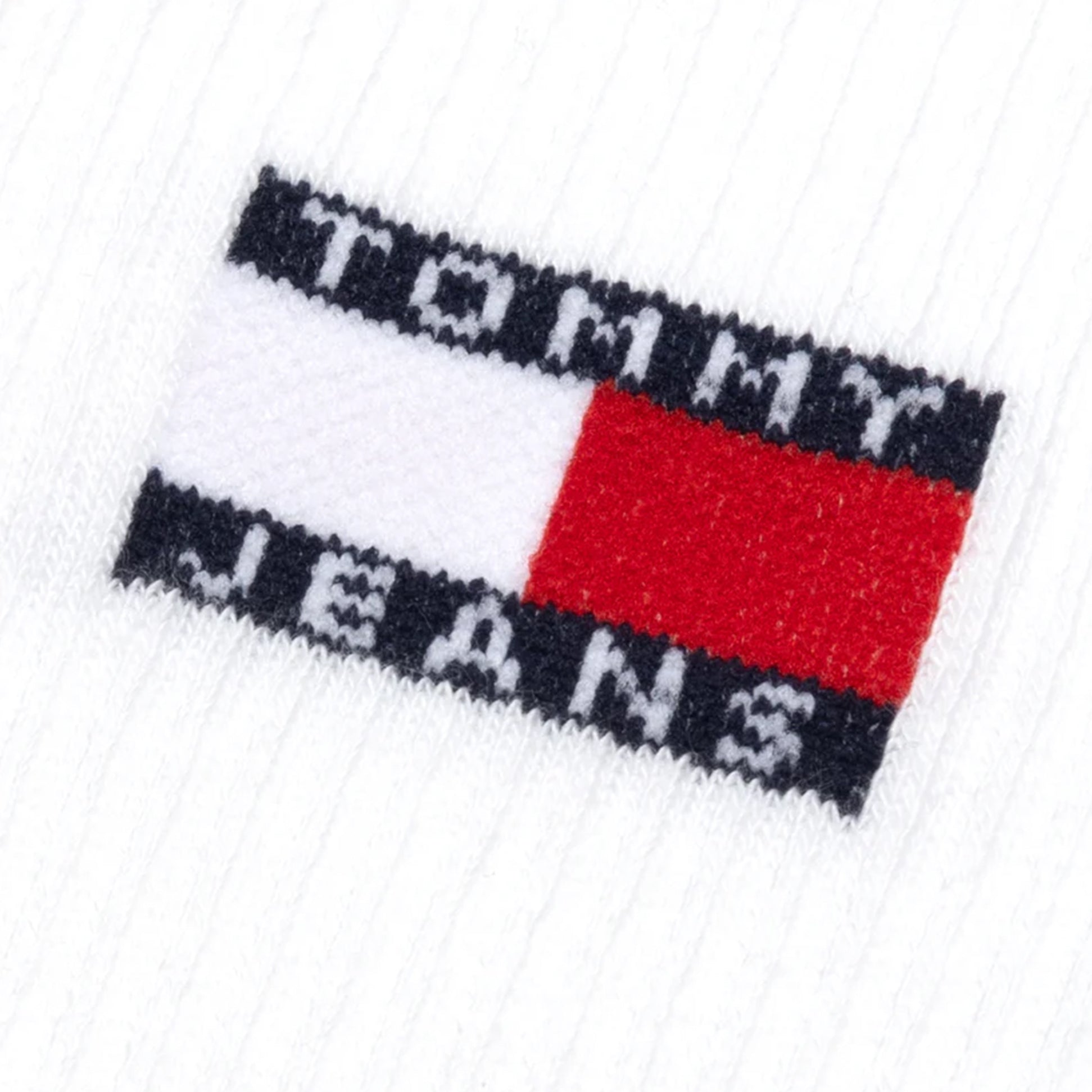 Detail view of Tommy Hilfiger 2 Pack Flag Trainer Mens Crew Socks White logo patch.