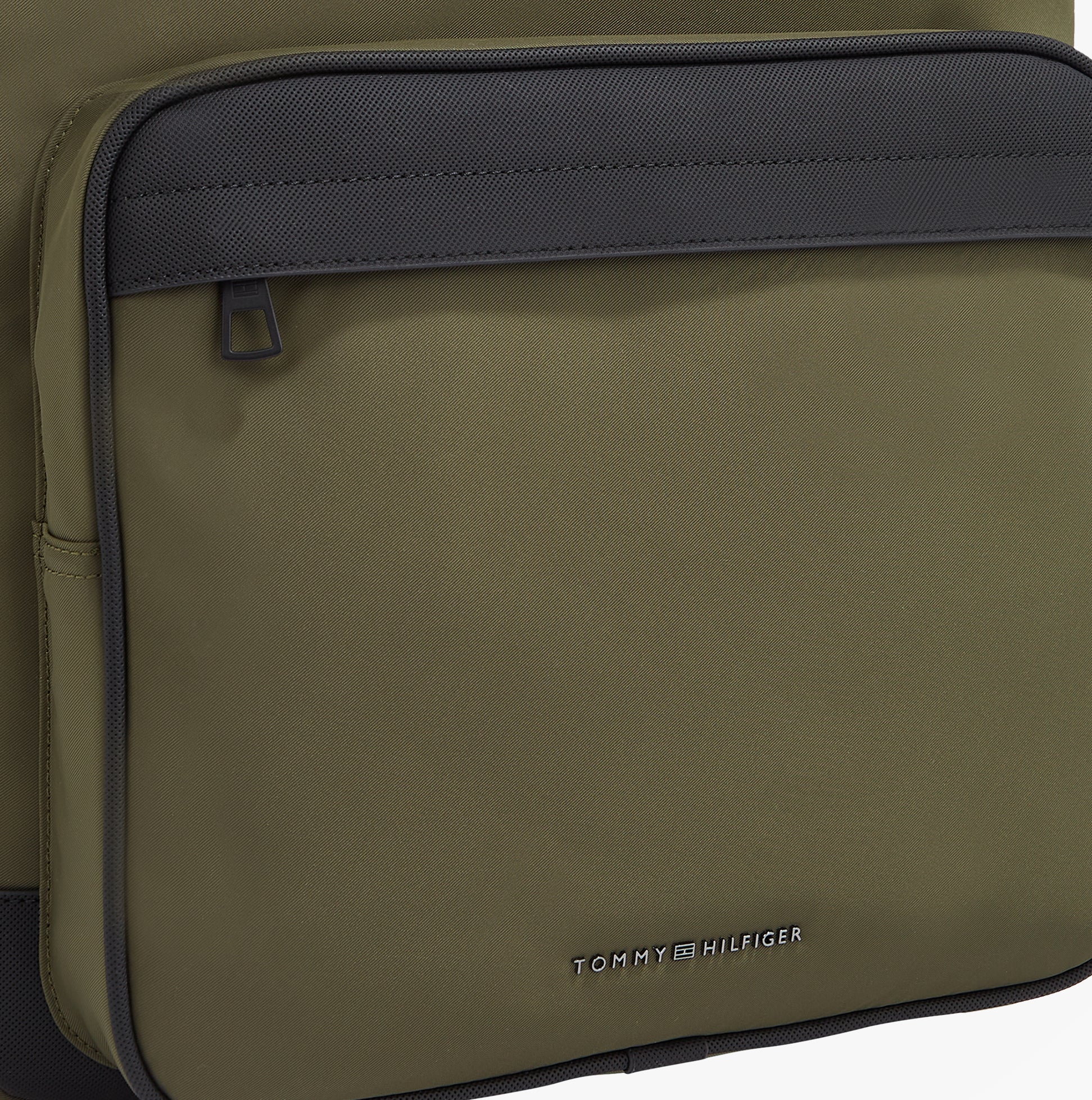 Detail view of Tommy Hilfiger REPREVE Metal Logo Backpack Army Green showing front pocket and brand logo.