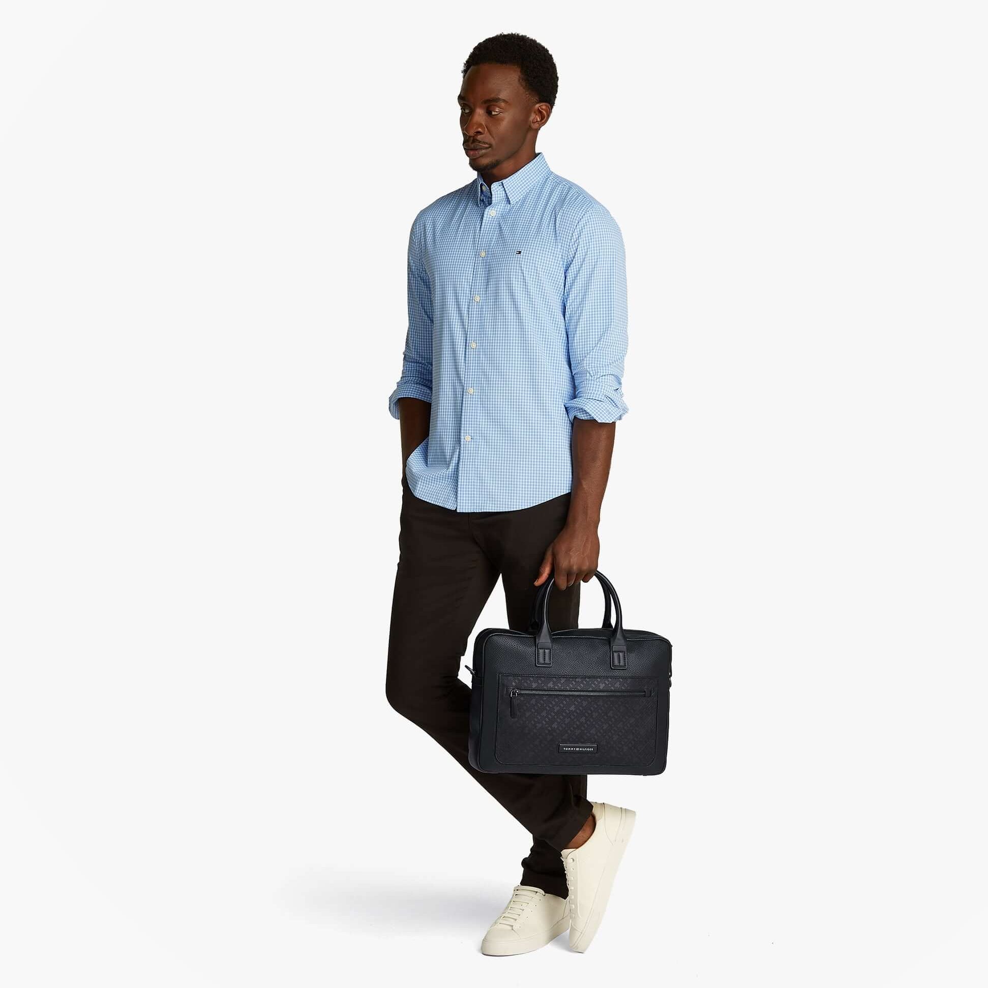 Tommy Hilfiger MONOGRAM PEBBLE GRAIN Mens Laptop Bag Black side view held by model in casual outfit