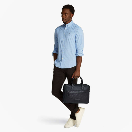 Tommy Hilfiger MONOGRAM PEBBLE GRAIN Mens Laptop Bag Black side view held by model in casual outfit