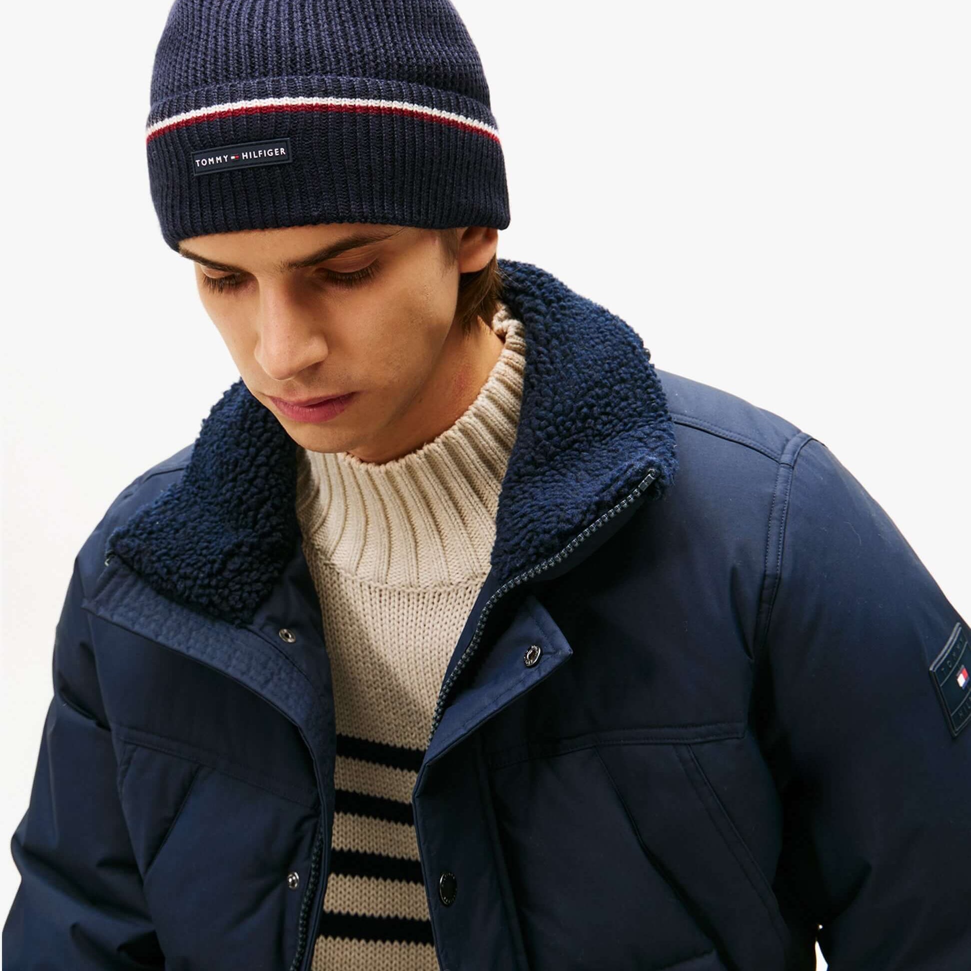 Tommy Hilfiger Signature Tape Mens Wool Beanie Blue worn by model, side view showing the beanie and jacket details.