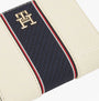Tommy Hilfiger Womens monogram wallet with TH signature Cream close-up view showing the logo and multicolor stripe design.