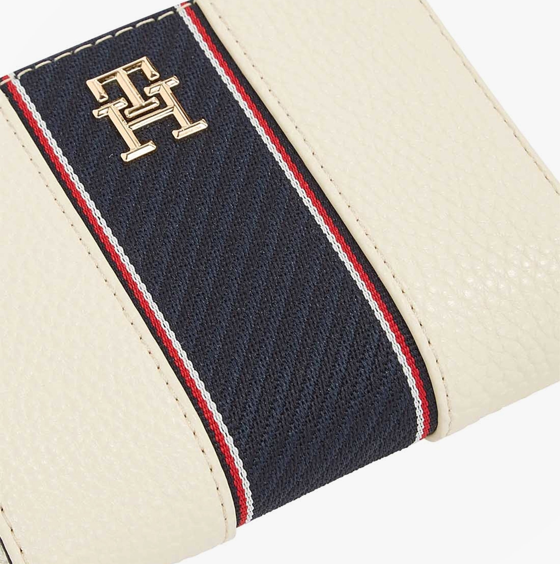Tommy Hilfiger Womens monogram wallet with TH signature Cream close-up view showing the logo and multicolor stripe design.