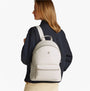 Tommy Hilfiger LOGOTAPE Womens Backpack Sugarcane side view on model with adjustable straps and TH monogram plaque.