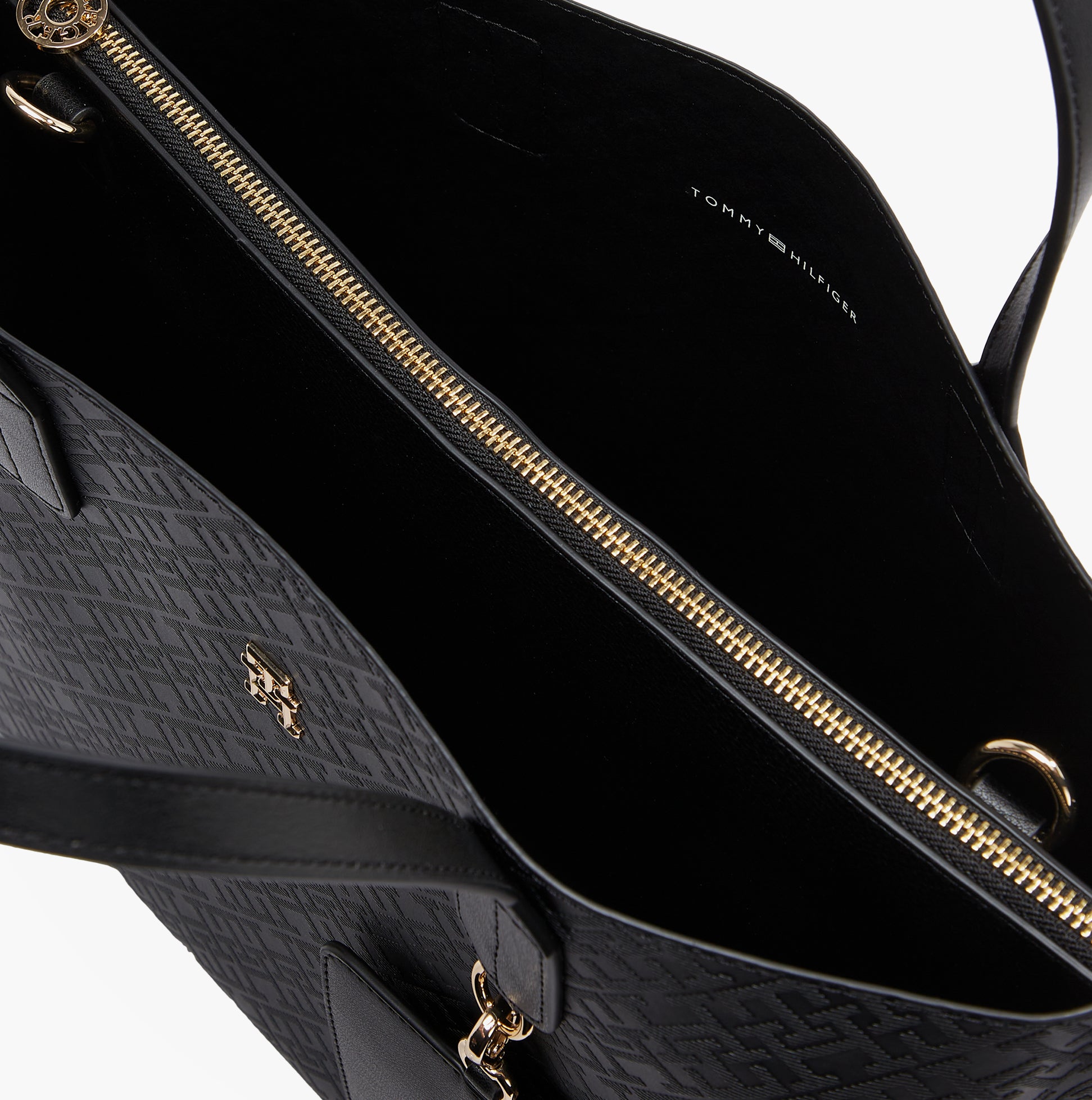 Tommy Hilfiger DISTINCT SATCHEL Womens Handbag Black interior view showing zip closure and embossed TH monogram design.