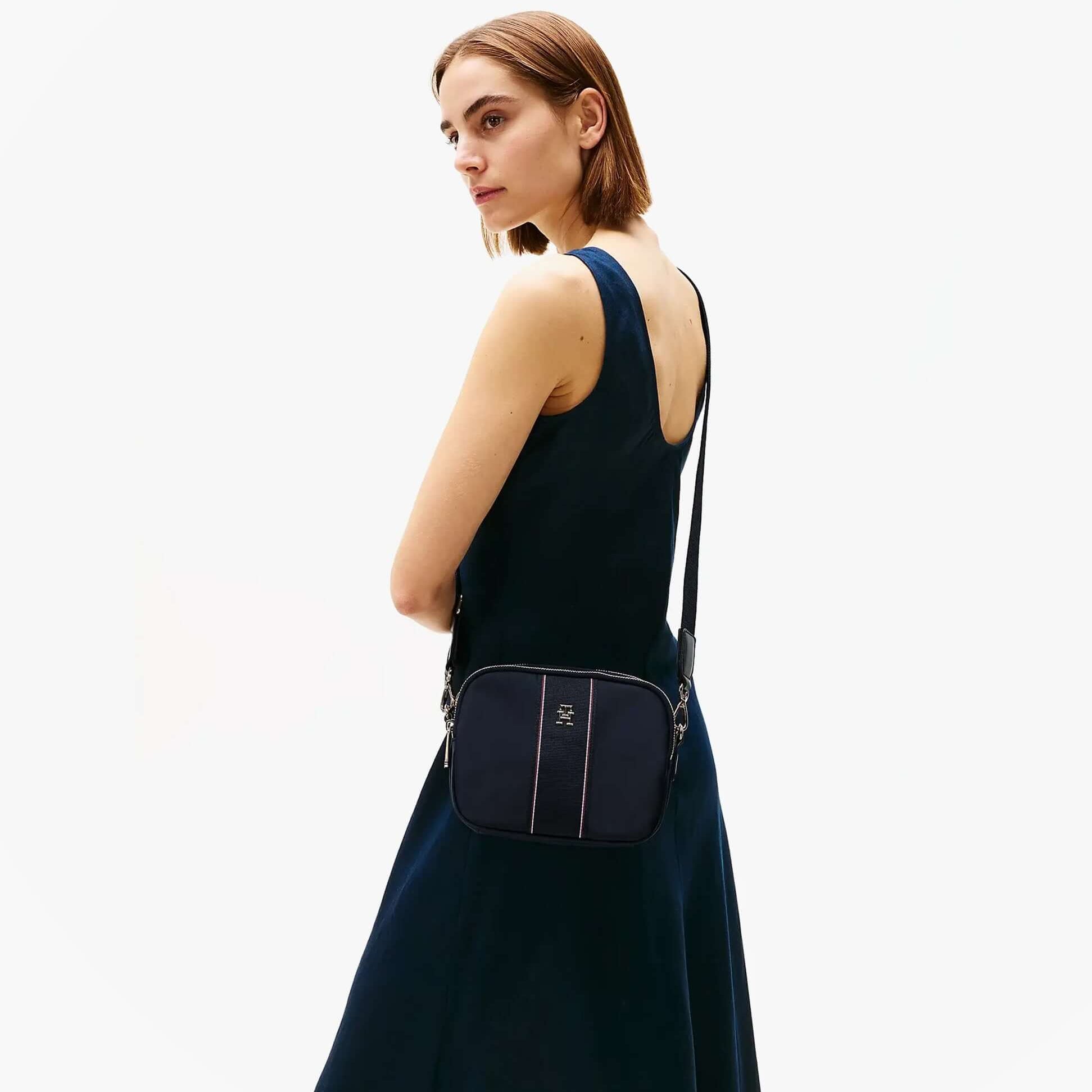 Tommy Hilfiger MONOGRAM CROSSBODY Womens Bag Space Blue Corp side view on model wearing a blue dress.