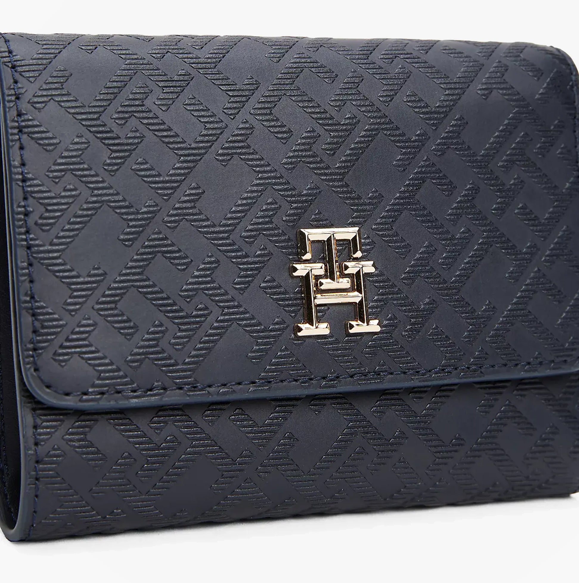 Tommy Hilfiger Womens Monogram Trifold Wallet Navy front view with textured pattern and gold logo detail.
