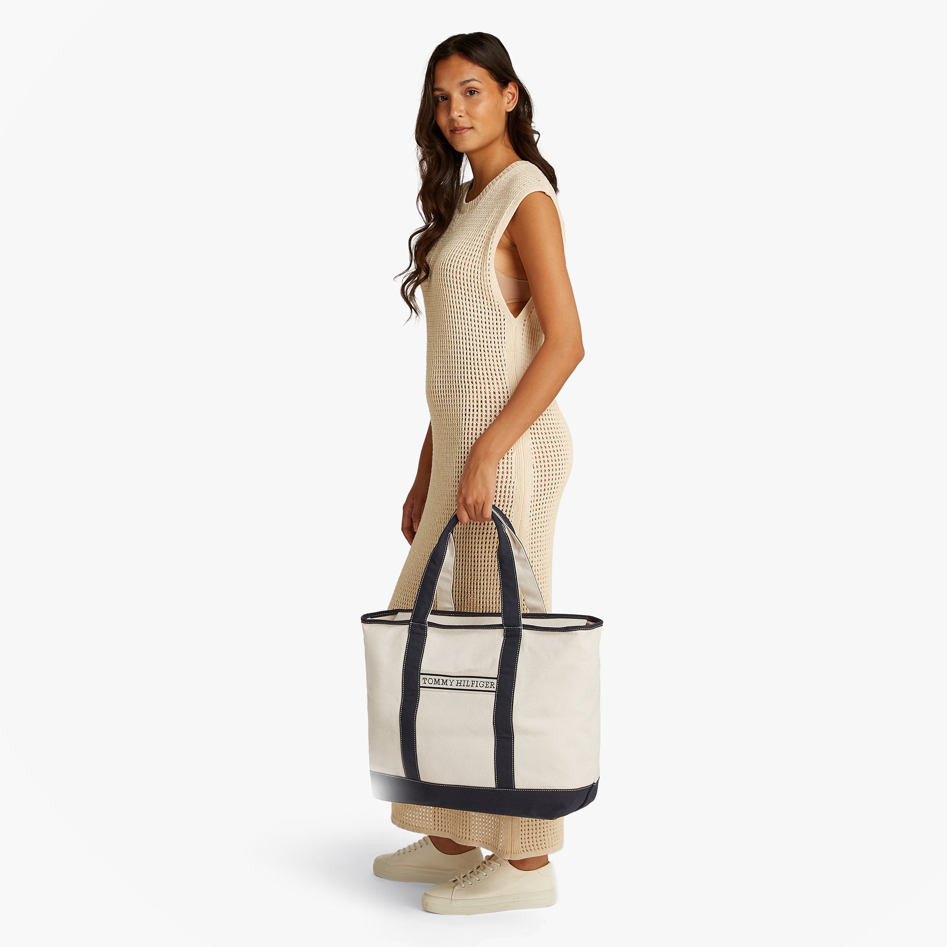 Tommy Hilfiger CANVAS BEACH Womens Tote Bag Space Blue side view, held by a model, showcasing the zip closure and contrast trim.