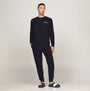 Tommy Hilfiger NYLON FLAG Mens Loafers Desert Sky side view with model wearing navy sweatshirt and pants.