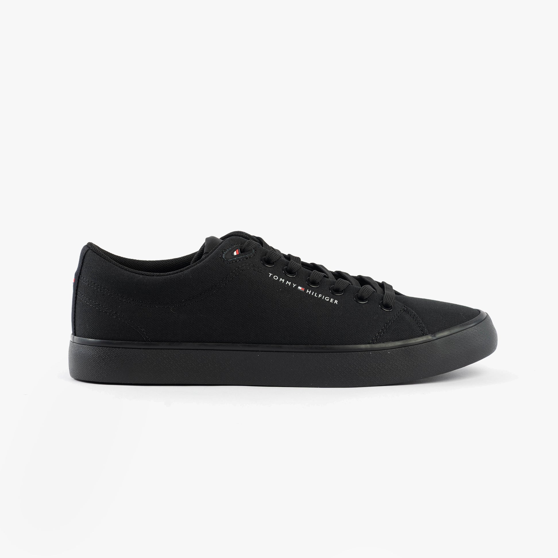 Tommy Hilfiger LOGO PATCH Mens Trainers Black side view featuring a low-top design with a lace-up closure.