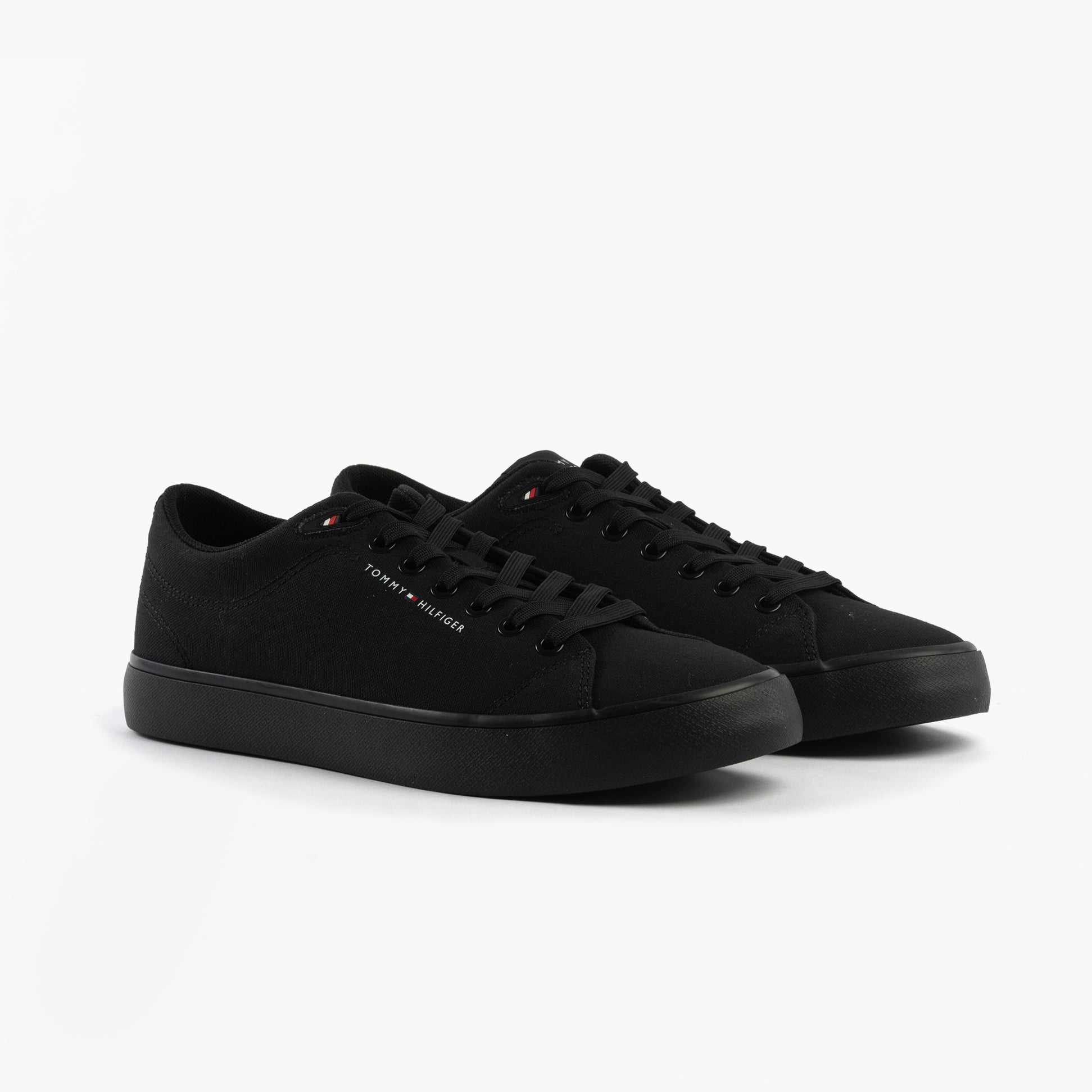 Tommy Hilfiger LOGO PATCH Mens Trainers Black side view showcasing the black cotton upper and lace-up closure.