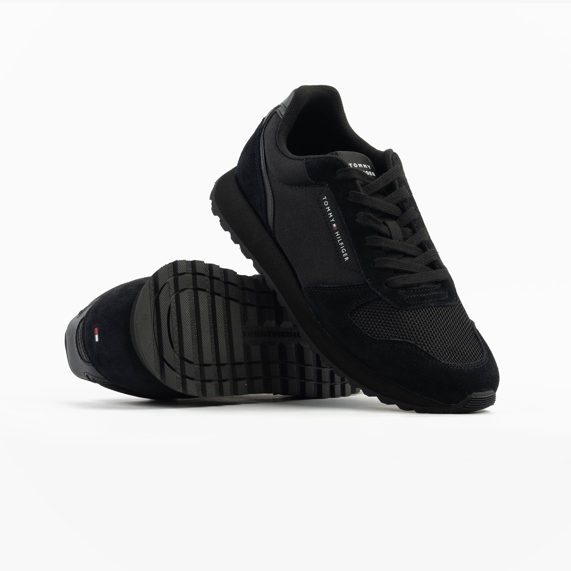 Tommy Hilfiger ESSENTIAL MIXED TEXTURE Mens Trainers Black side view showing mesh and suede design with rubber sole.