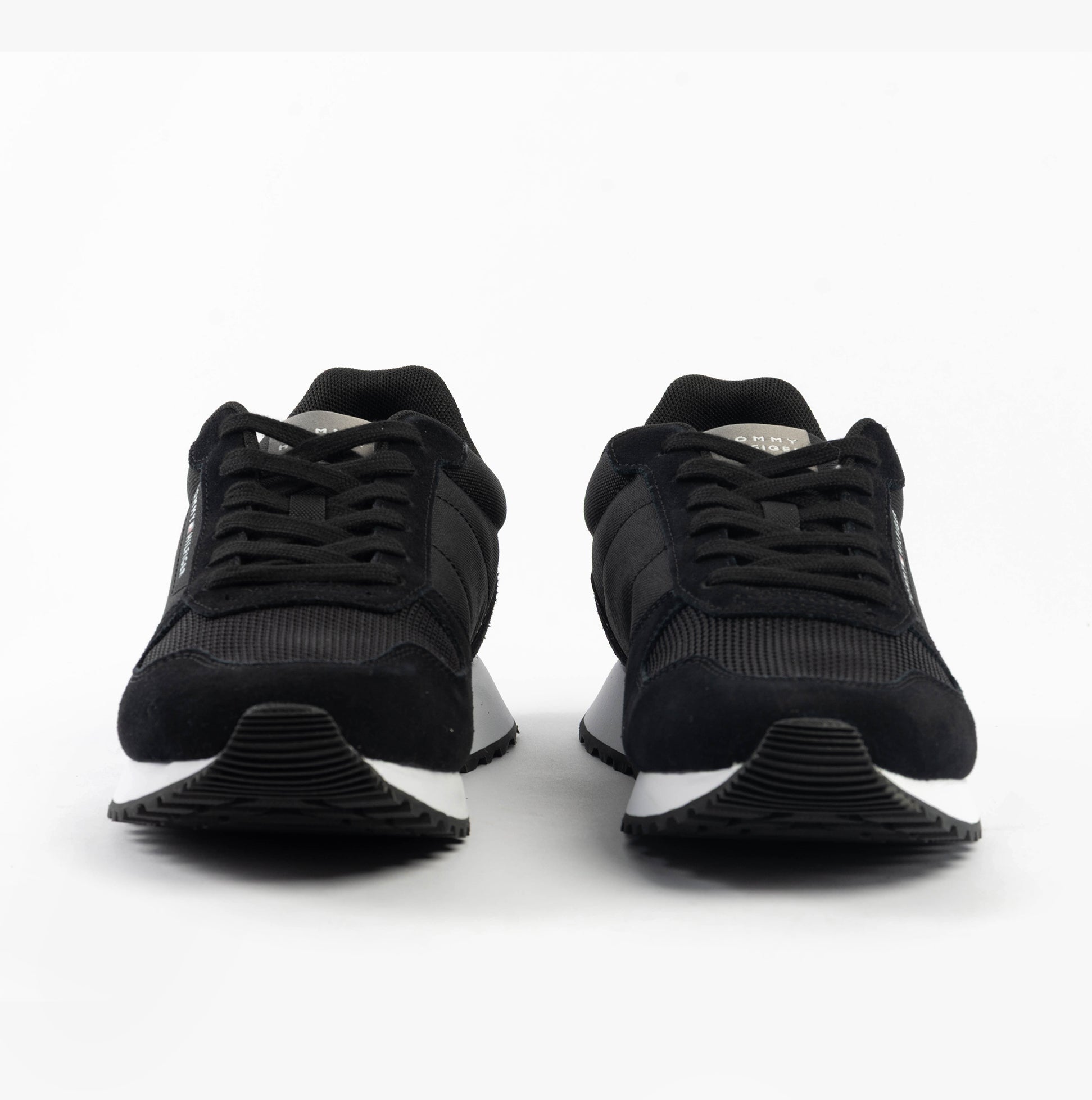 Tommy Hilfiger SUEDE LOGO Mens Trainers Black front view showing lace-up design and low top silhouette.