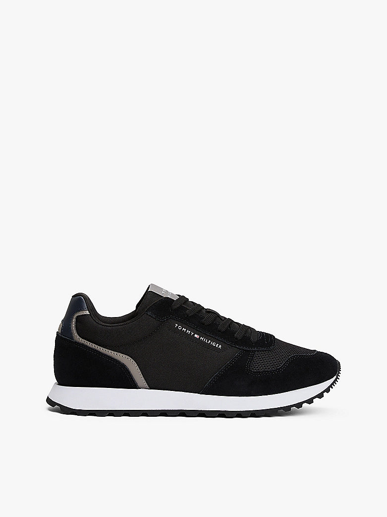 Tommy Hilfiger SUEDE LOGO Mens Trainers Black side view showing sleek design and lace-up closure.