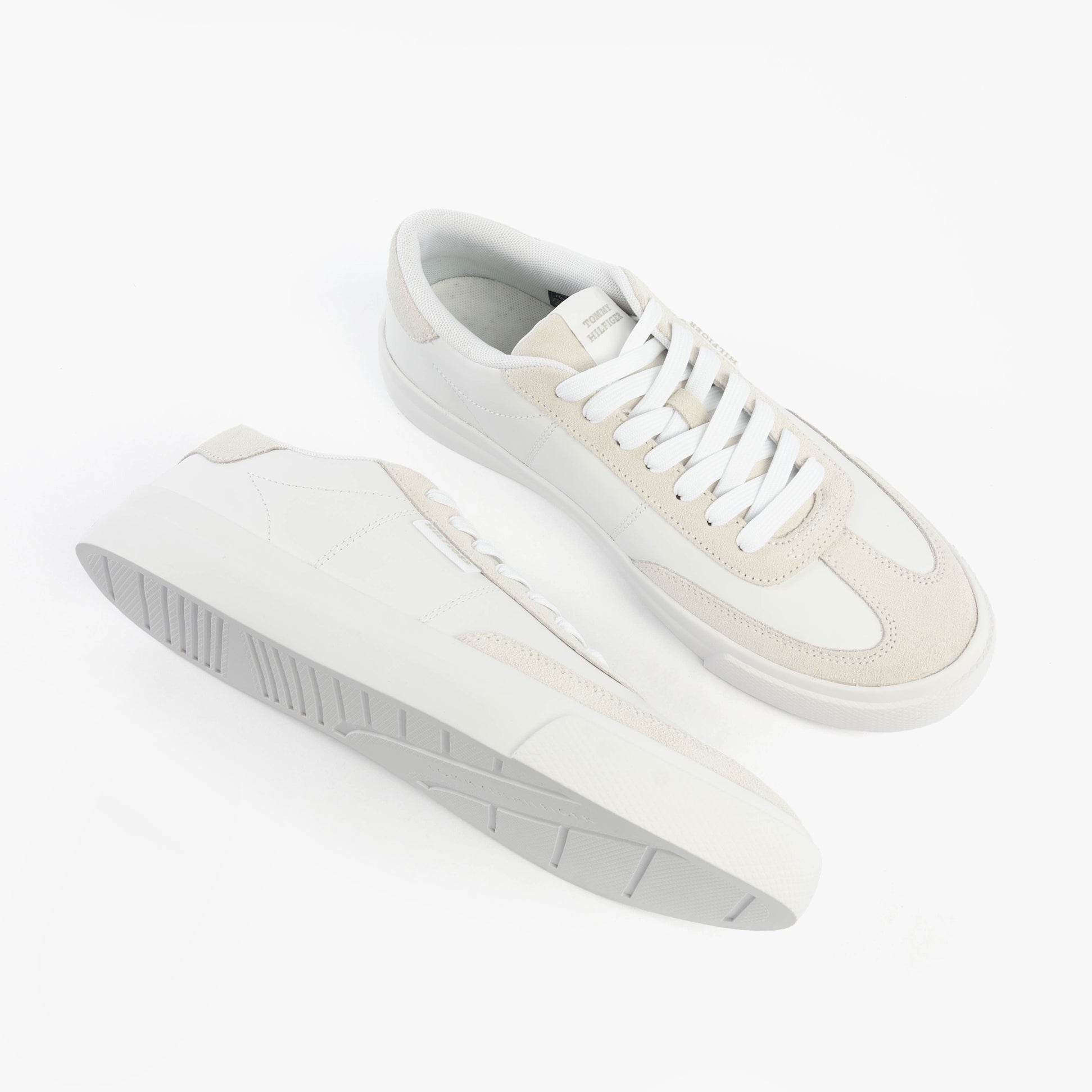 Tommy Hilfiger SUEDE CONTRAST CUPSOLE Mens Trainers White top side view showing lace-up design and rubber sole.