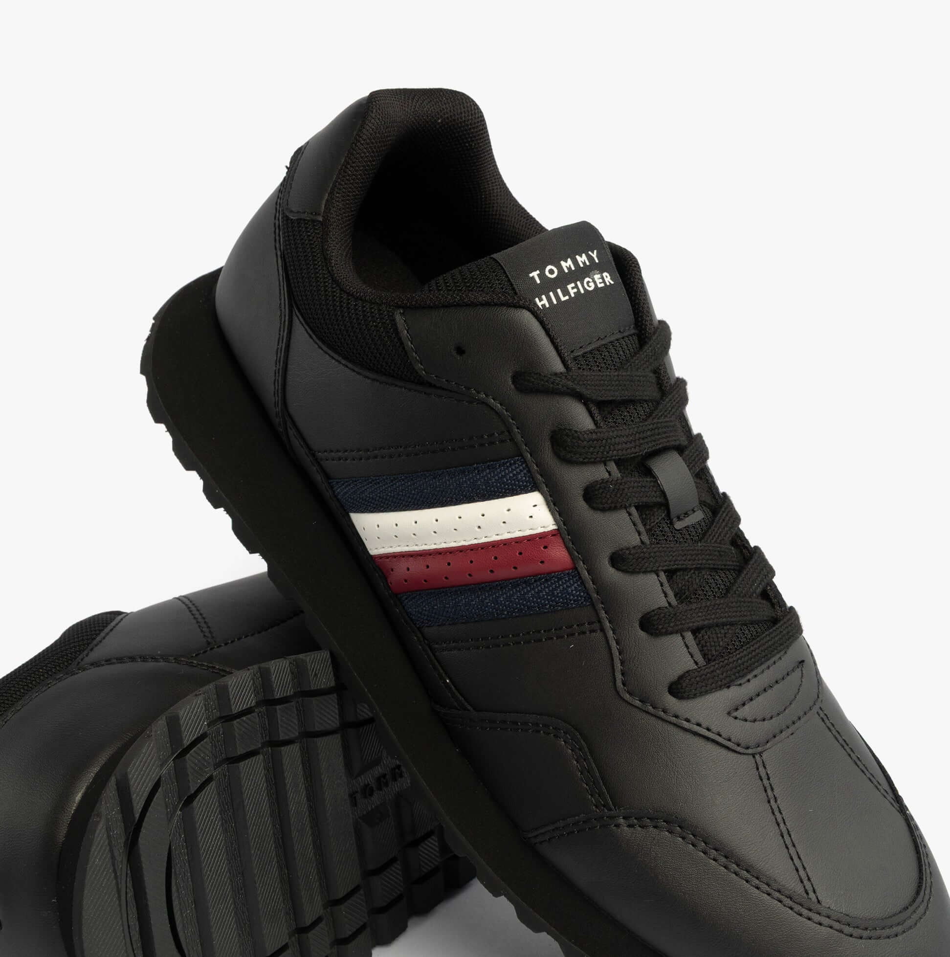 Tommy Hilfiger Mens Signature Tape Cleat Leather Trainers Black top view showing details and color accents.