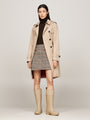 Tommy Hilfiger RUBBER Womens Welly Boots Beige worn with a beige trench coat and plaid skirt, front view.