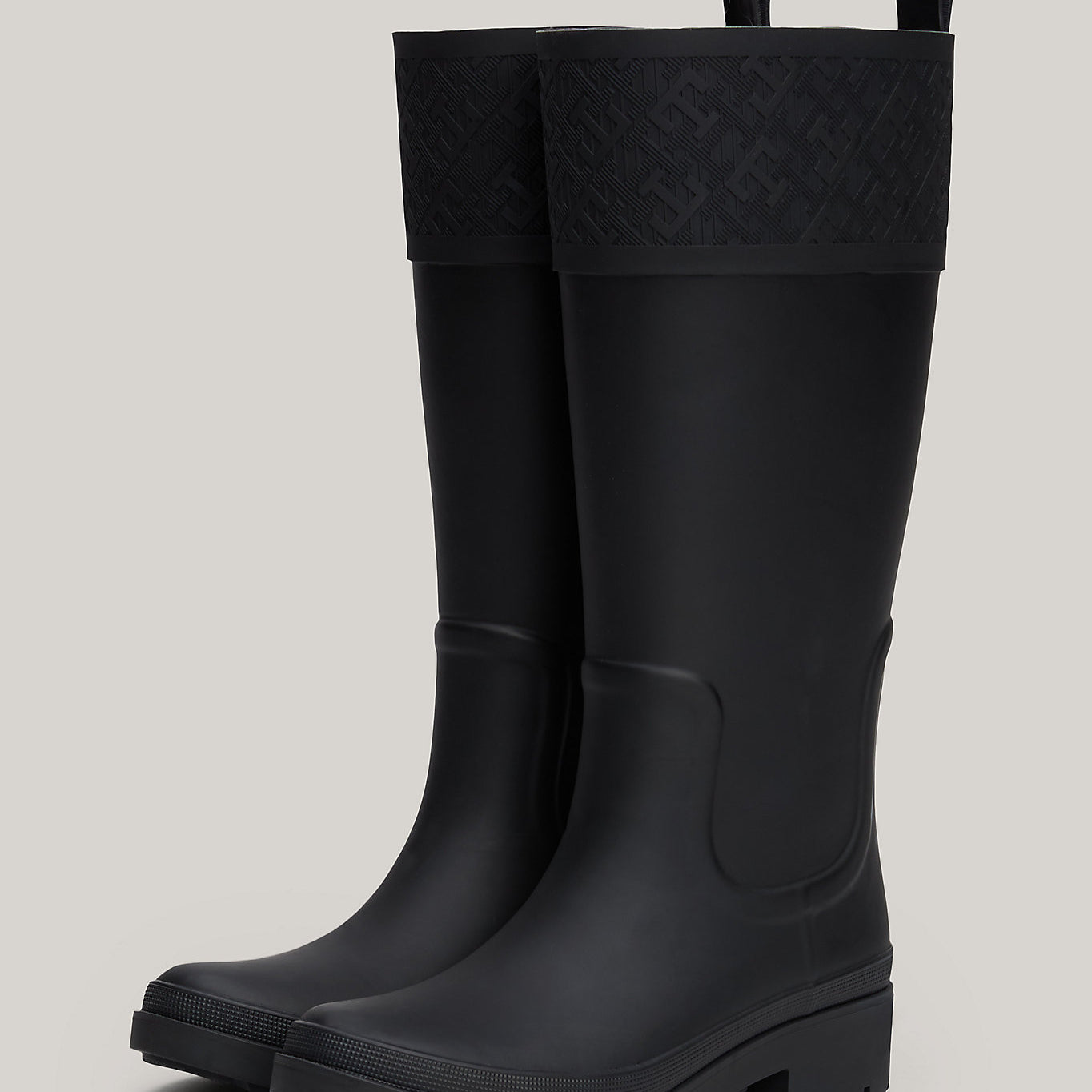 Tommy Hilfiger RUBBER Womens Long Boots Black side view showcasing knee-high design and pull-on features.