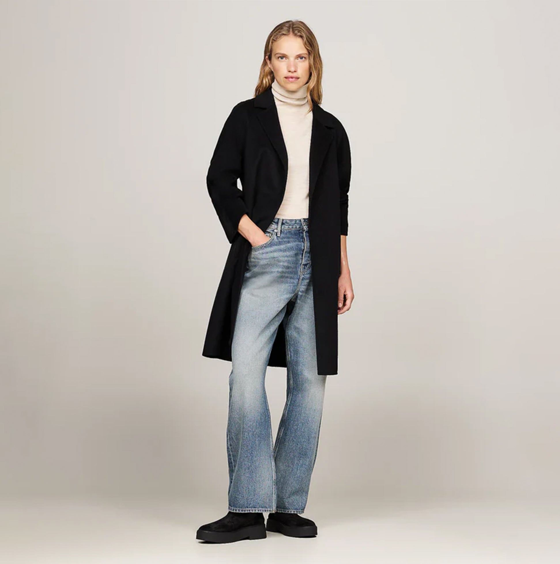 Tommy Hilfiger MINIMAL SUEDE Womens Chelsea Boots Black side view with model wearing stylish outfit including a long coat.
