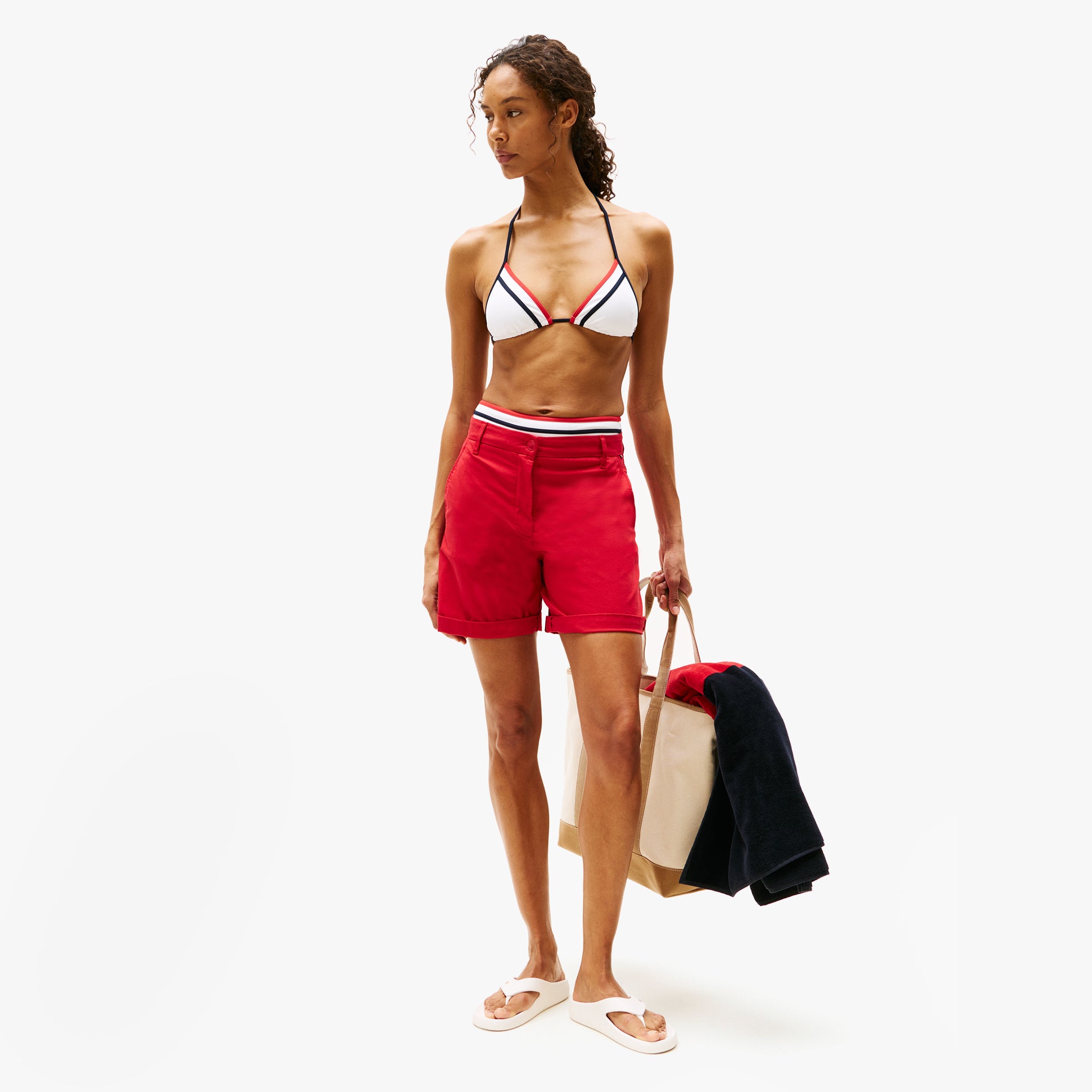 Tommy Hilfiger ENAMEL FLAG CONTOURED Womens Sandals Ancient White worn with red shorts and bikini in a side view.