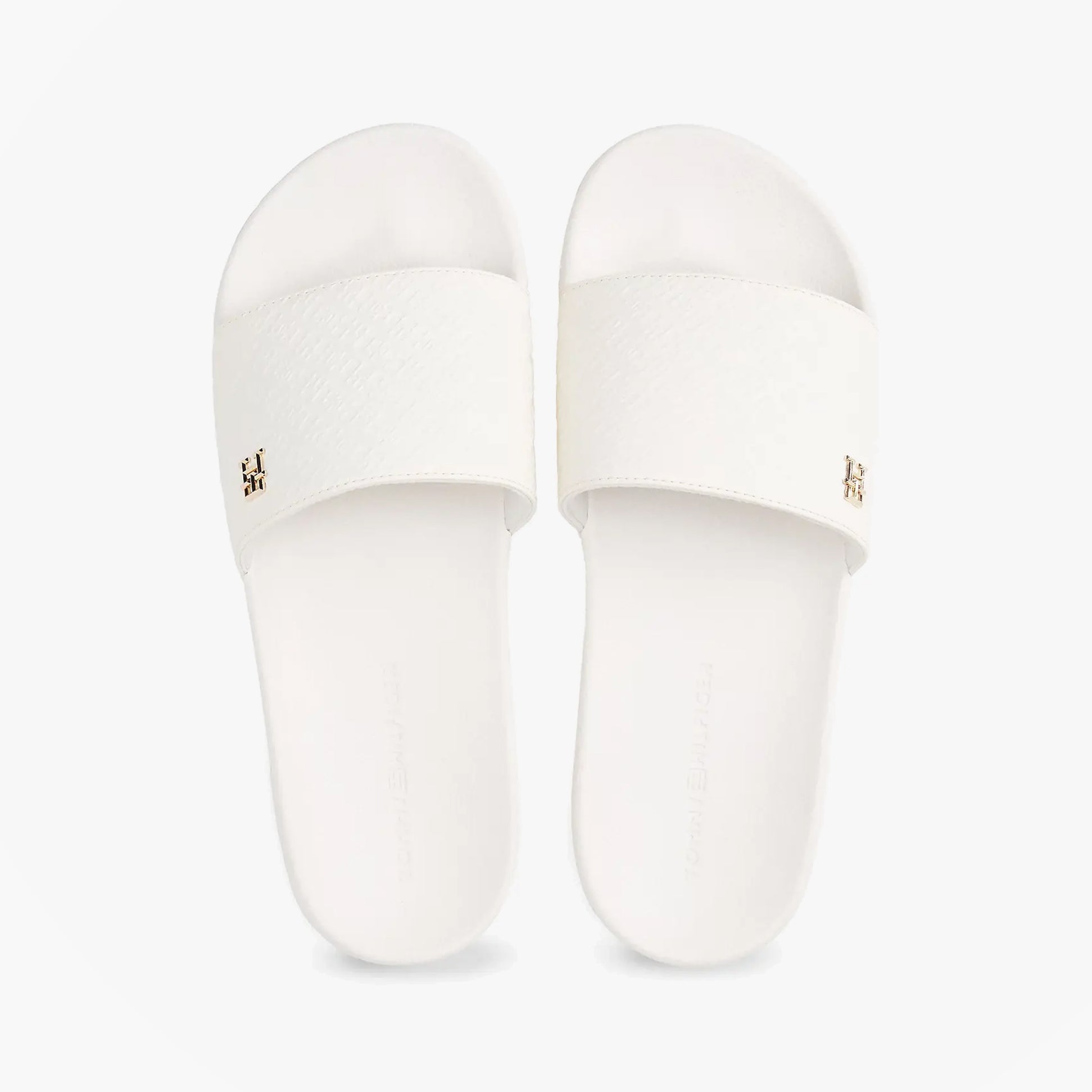 Tommy Hilfiger MONOGRAM POOLSIDE Womens Sliders White top view with embossed TH monogram and gold plaque.